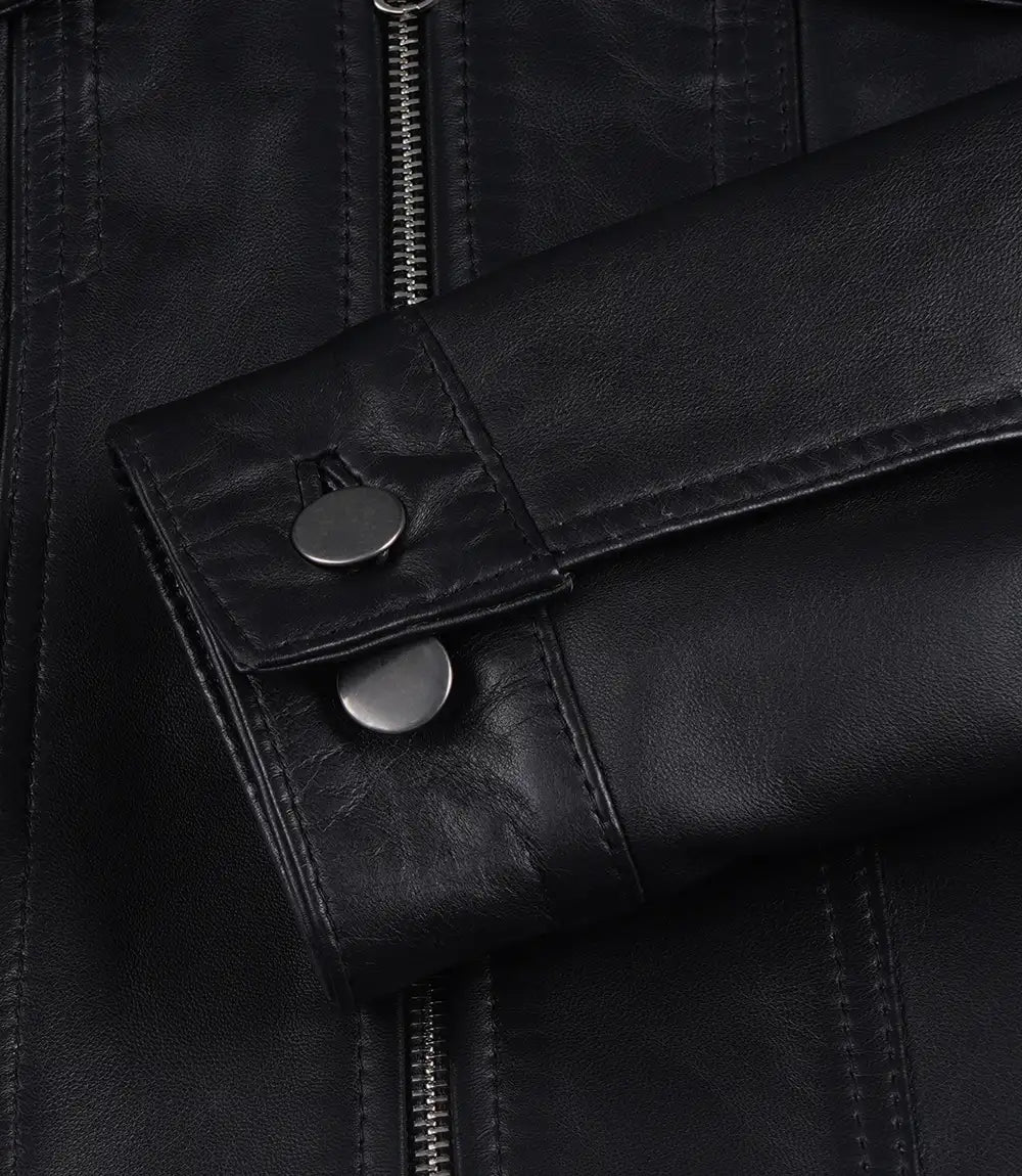 Close-up of Elara black leather jacket showing button cuffs and stitched sleeve edges