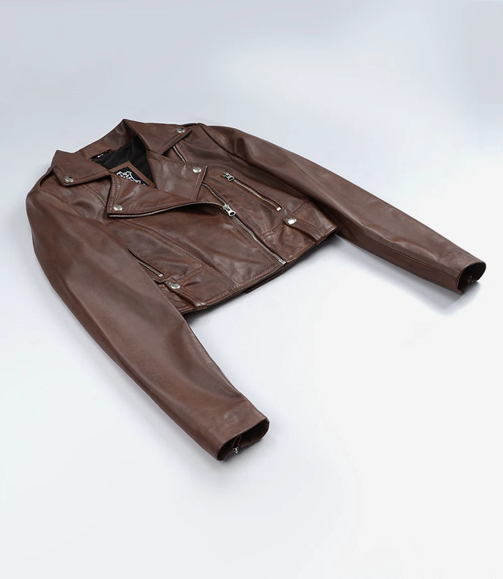 Rhea women's brown cropped leather biker jacket laid flat, showing long sleeves and asymmetric front zip