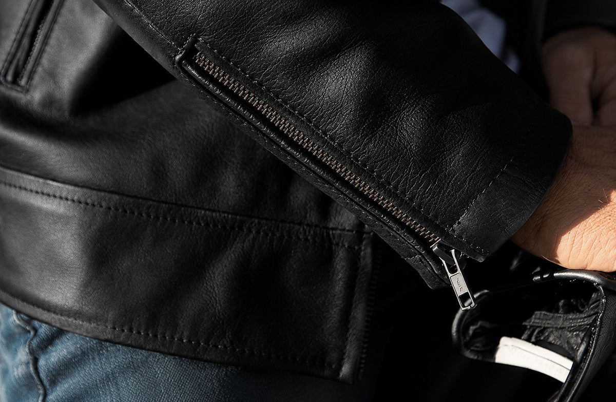 Close-up of leather texture, stitching and a jacket zip