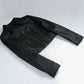 Cora women's black cropped zip-up leather jacket laid flat, showing pointed collar and long sleeves