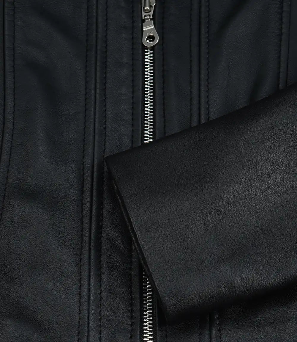 Close-up of Cora black leather jacket's front zip, panel stitching and plain sleeve cuff