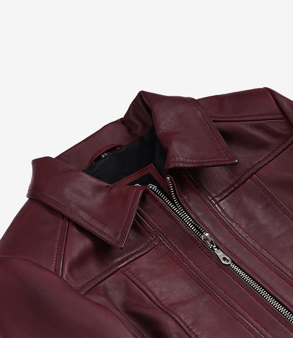 Close-up of Cora burgundy leather jacket's pointed collar, front zip and panel stitching