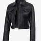 Angled front view of Elara women's black cropped leather trucker jacket with a front zip and flap chest pockets