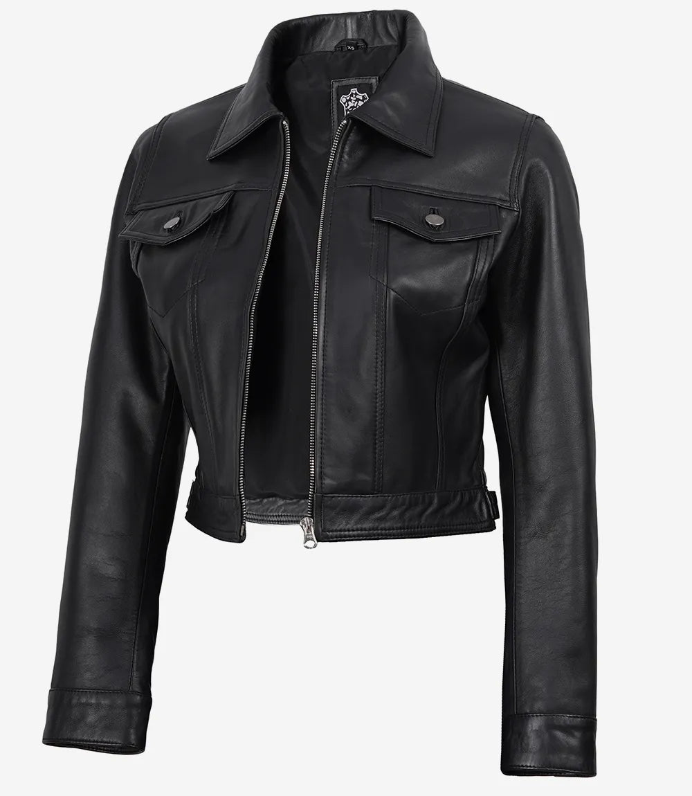 Angled front view of Elara women's black cropped leather trucker jacket with a front zip and flap chest pockets