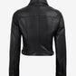 Back view of Elara women's black cropped leather trucker jacket showing panel seams and adjustable waist tabs