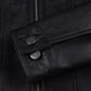 Close-up of Elara black leather jacket showing button cuffs and stitched sleeve edges