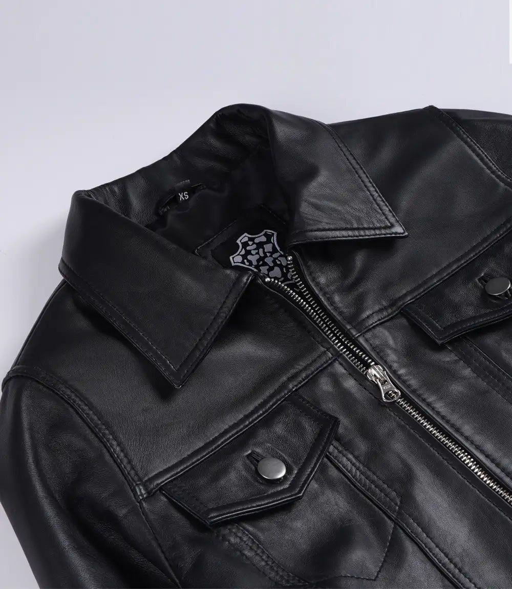 Close-up of Elara black leather jacket showing the pointed collar, silver-tone zip and flap chest pockets