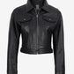 Zipped front view of Elara women's black cropped leather trucker jacket with a pointed collar and chest pockets