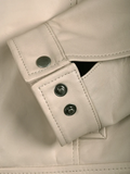 Close-up of cuff and button detailing on beige leather Harrington jacket | NSM Jackets