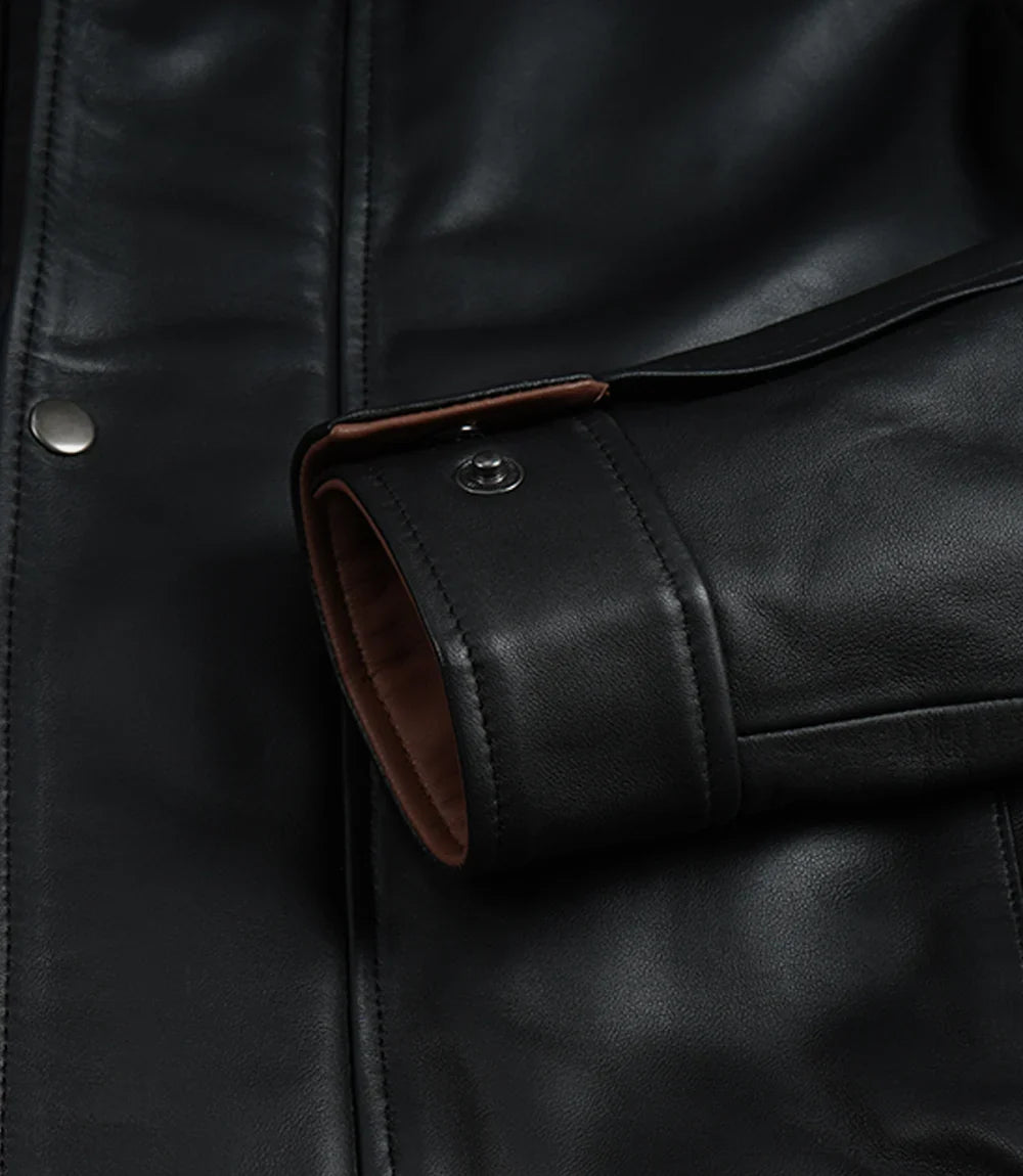 Men's black leather jacket features, pocket and cuff detail
