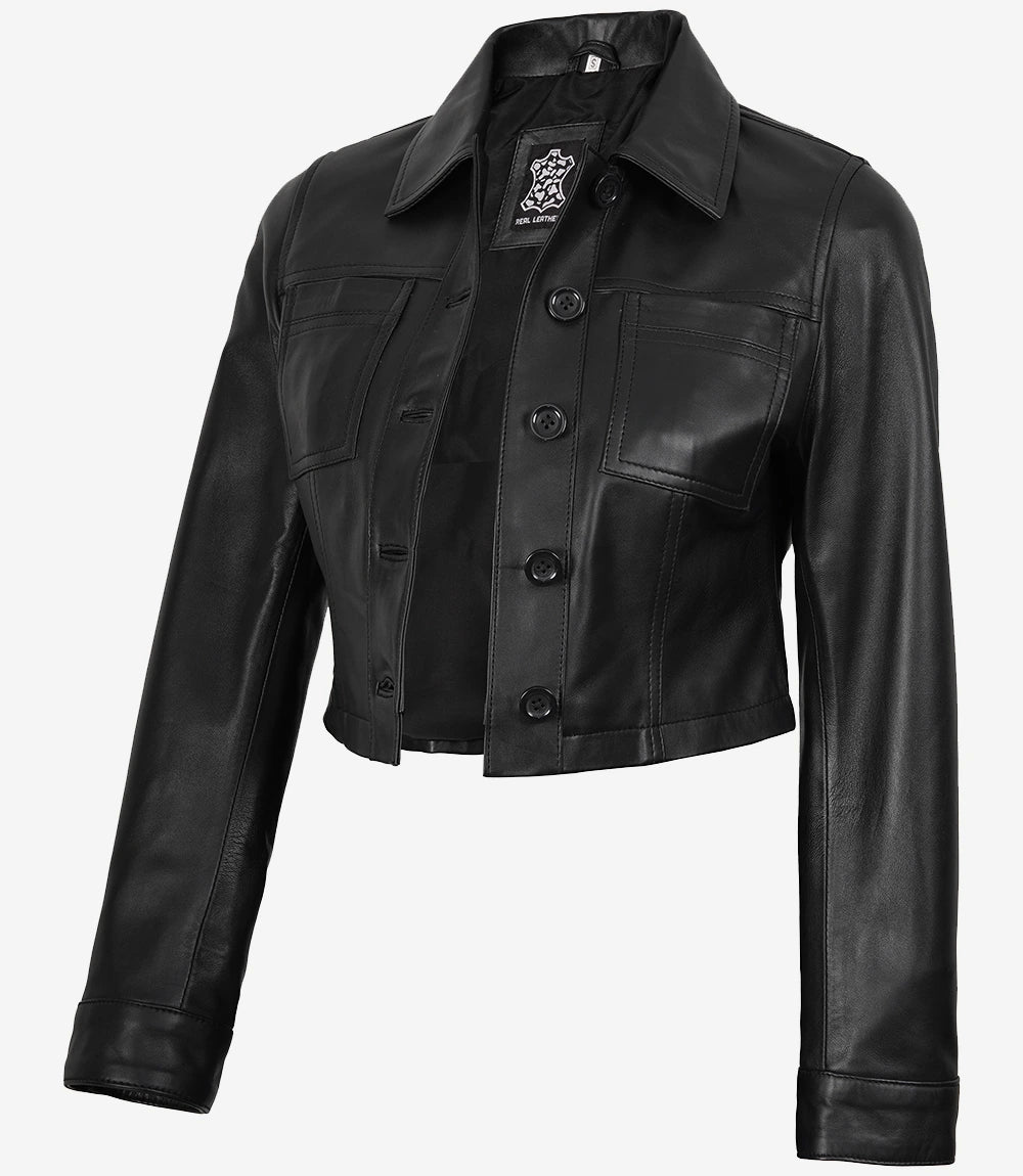 Angled front view of Mila women's black cropped leather trucker jacket showing the button fastening and cropped hem