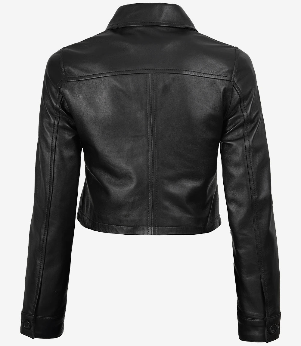 Back view of Mila women's black cropped leather trucker jacket showing panel seams and button cuffs