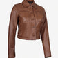 Angled buttoned front view of Mila women's brown cropped leather trucker jacket showing the cropped hem