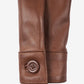 Close-up of Mila brown leather jacket showing a button cuff and sleeve stitching