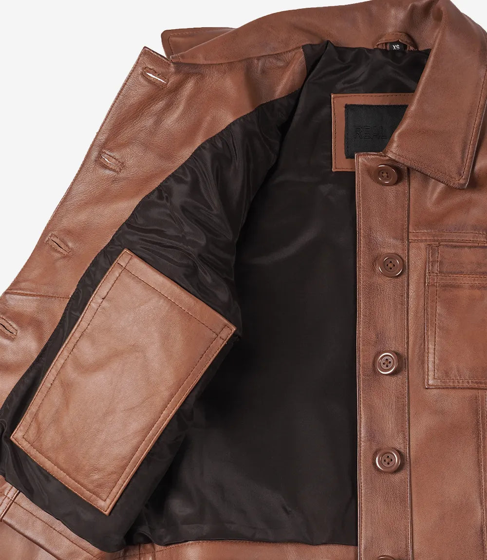 Inside view of Mila brown leather jacket showing the black lining and leather-trimmed inner pocket