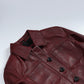 Close-up of Mila burgundy leather trucker jacket's pointed collar, chest pockets and black buttons