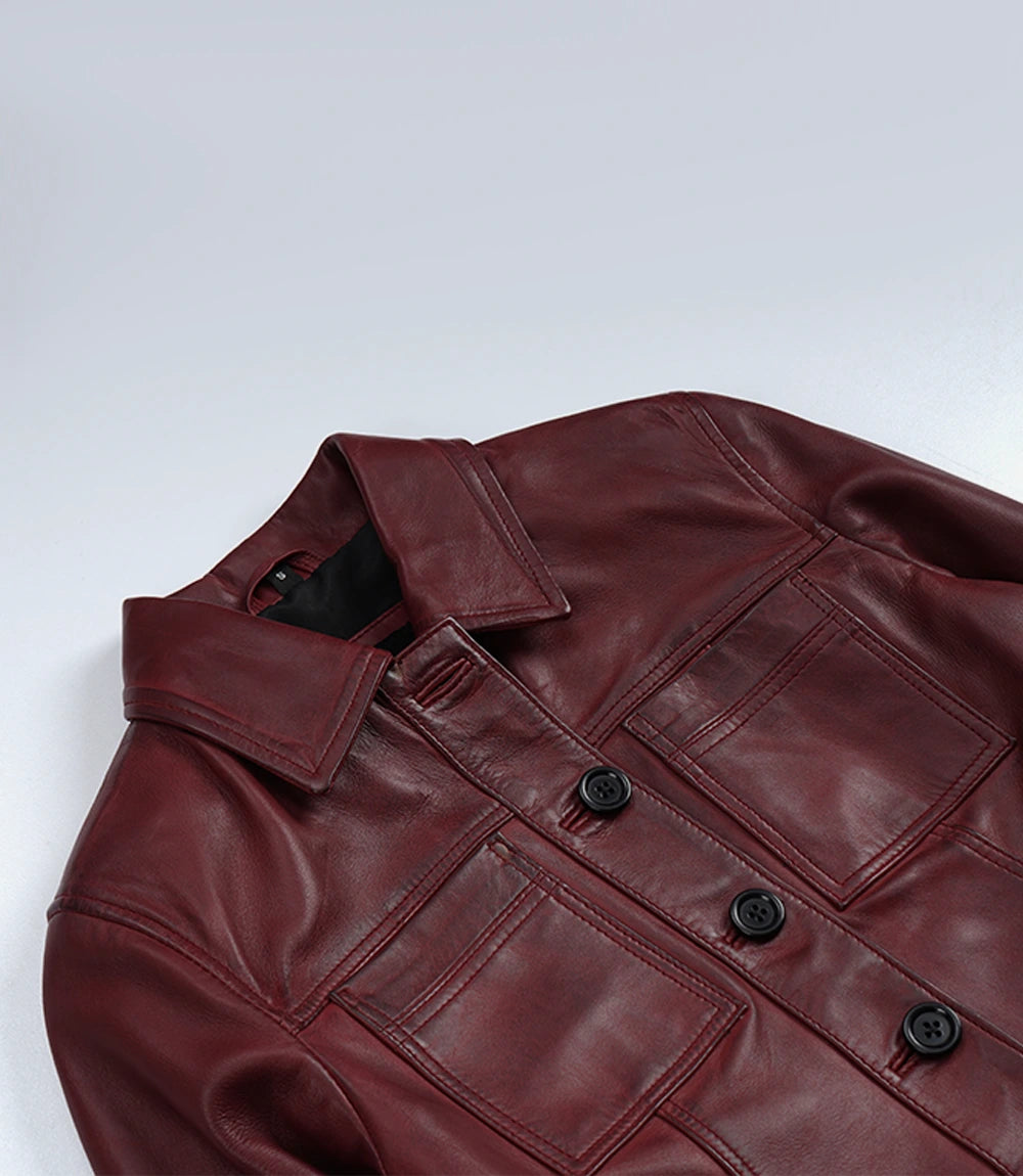 Close-up of Mila burgundy leather trucker jacket's pointed collar, chest pockets and black buttons