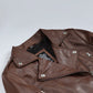 Close-up of Rhea brown leather biker jacket's snap lapels and asymmetric front zip