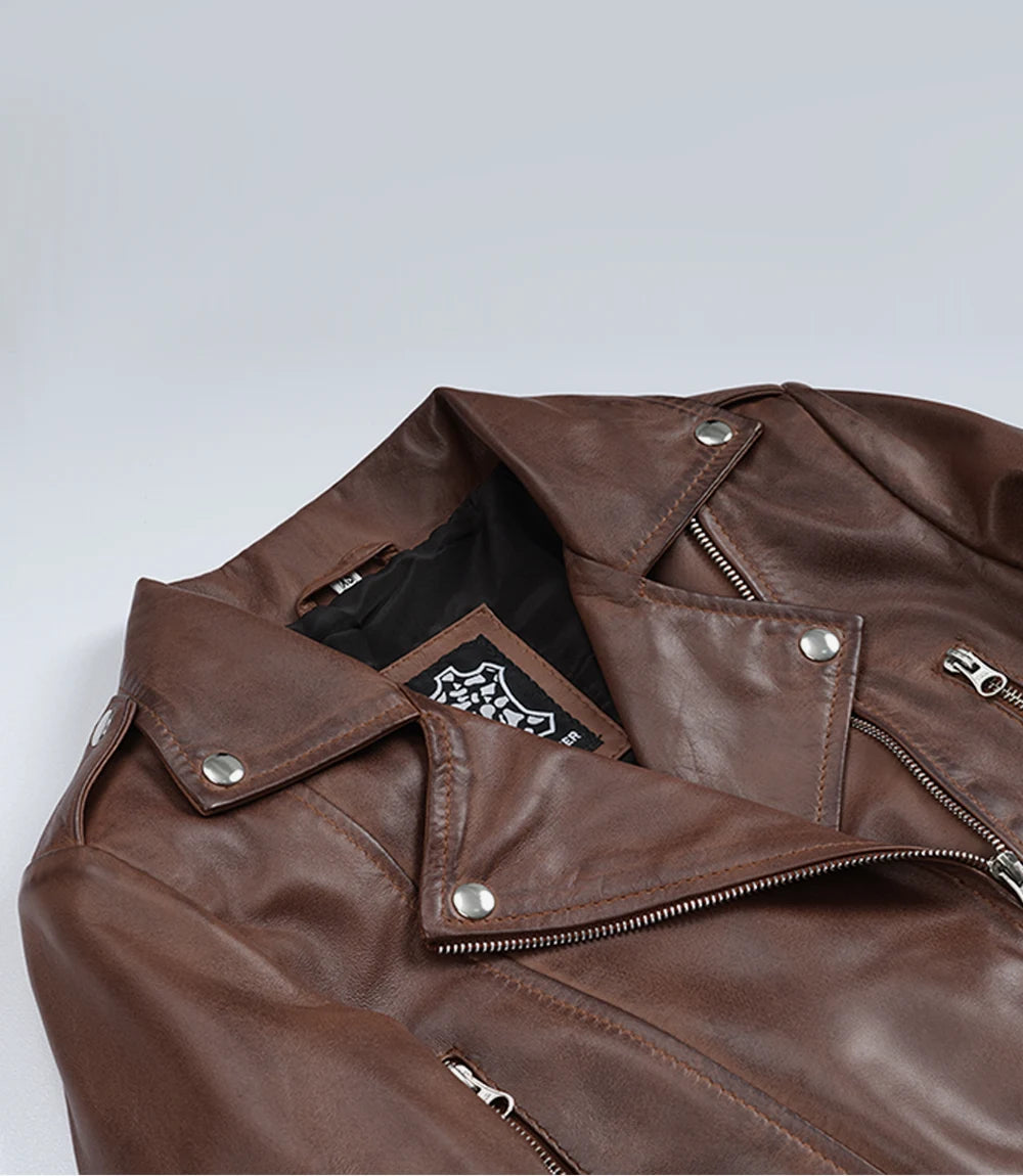 Close-up of Rhea brown leather biker jacket's snap lapels and asymmetric front zip