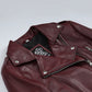 Close-up of Rhea burgundy leather biker jacket's snap lapels and asymmetric front zip