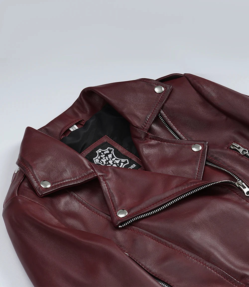 Close-up of Rhea burgundy leather biker jacket's snap lapels and asymmetric front zip
