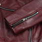 Close-up of the zipped sleeve cuff on Rhea women's burgundy leather biker jacket