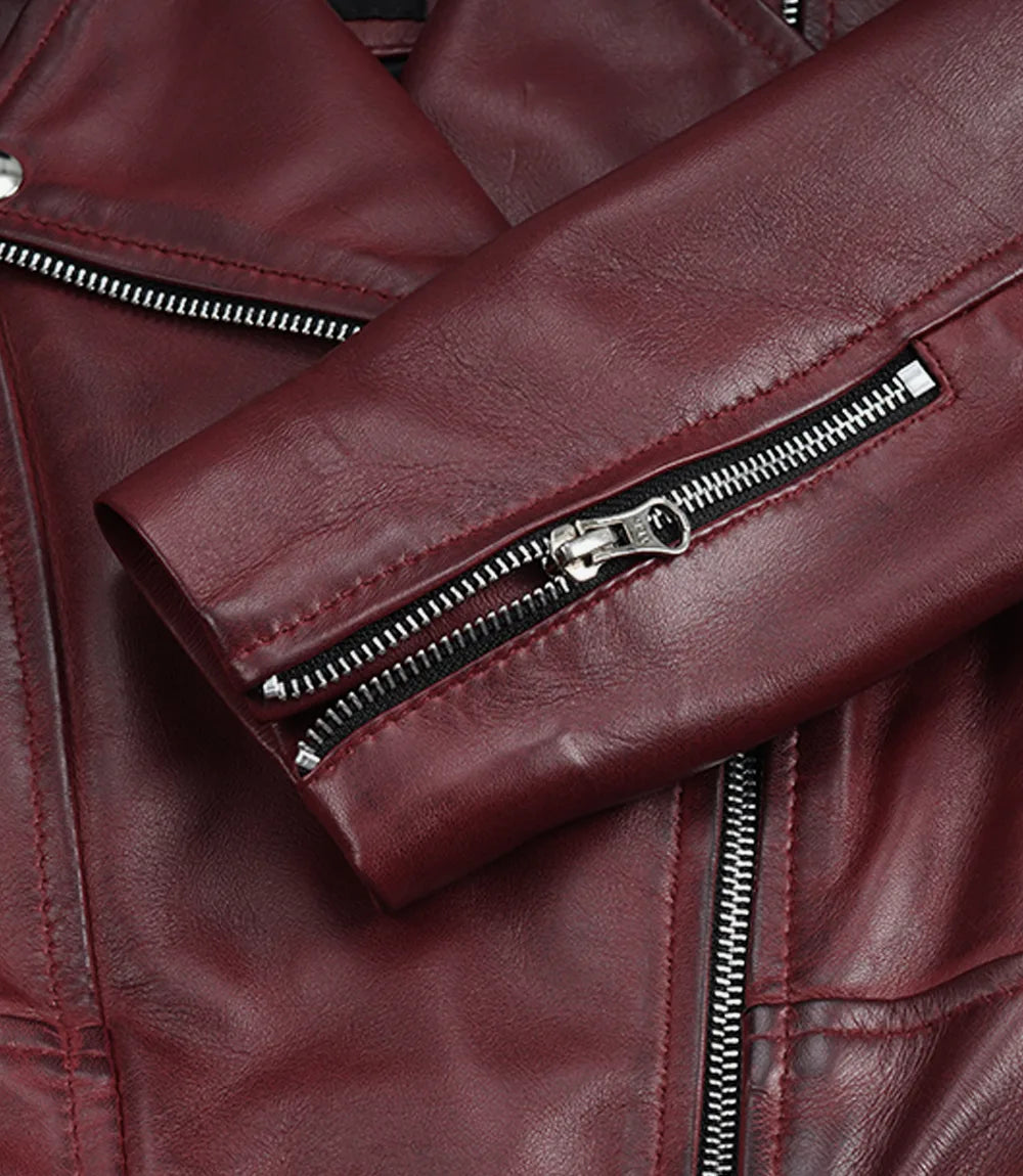 Close-up of the zipped sleeve cuff on Rhea women's burgundy leather biker jacket