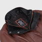 Close-up of Rowan jacket's black contrast collar, snap fasteners and front zip