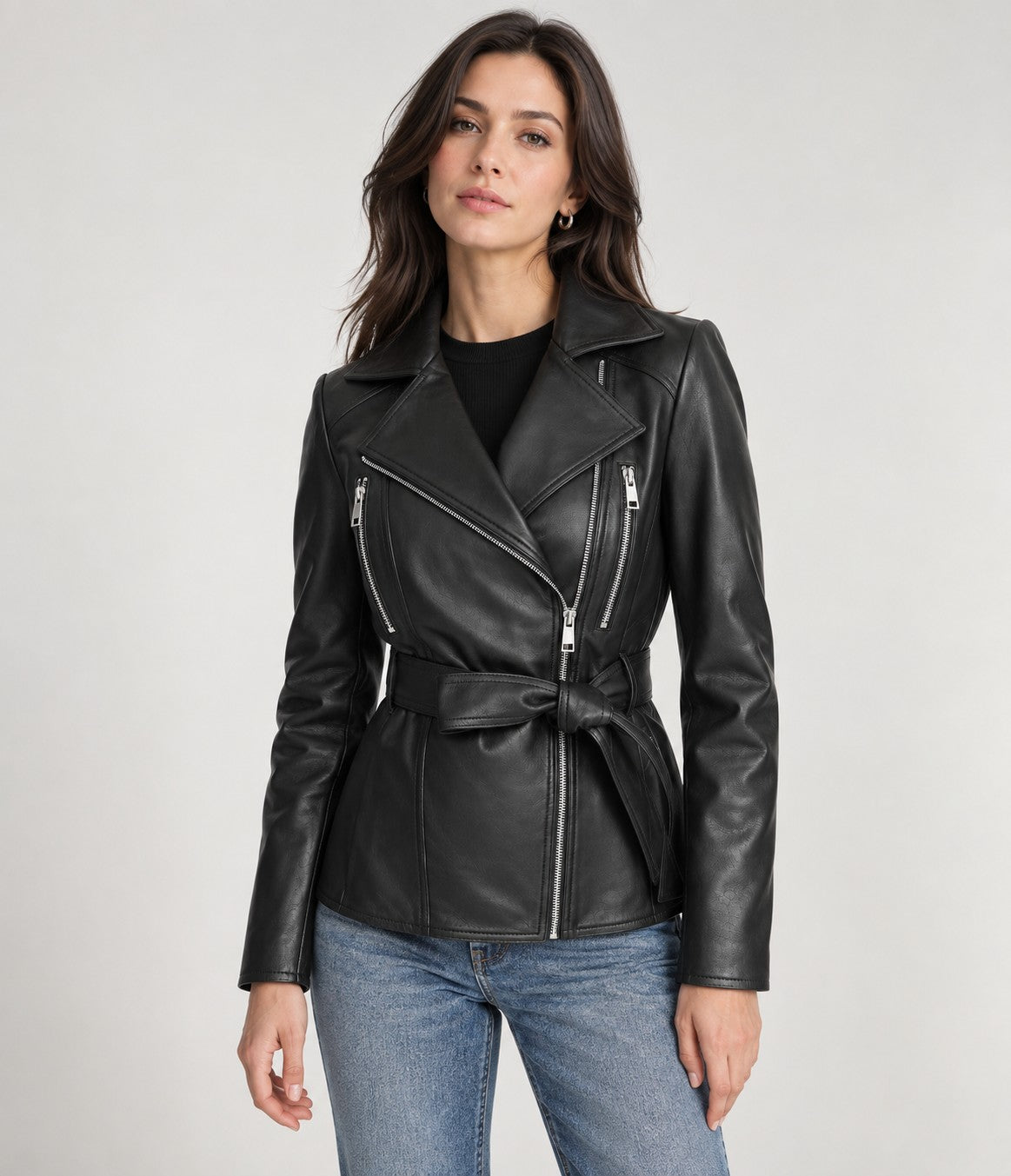 Woman wearing the Vesper black belted leather biker jacket with jeans